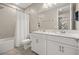 Spacious bathroom with double vanity, white cabinets, and modern fixtures at 14321 Wabasso Loop, Winter Garden, FL 34787