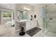 Bright bathroom with double sinks, neutral decor, a glass shower, and natural light at 14321 Wabasso Loop, Winter Garden, FL 34787
