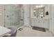 Bright bathroom featuring a glass shower enclosure, double vanity, and tile flooring at 14321 Wabasso Loop, Winter Garden, FL 34787