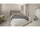 Cozy bedroom with tufted headboard, ample light, and a desk workstation at 14321 Wabasso Loop, Winter Garden, FL 34787