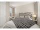 Bright bedroom featuring a tufted headboard, plush bedding, and a charming vanity area at 14321 Wabasso Loop, Winter Garden, FL 34787