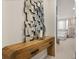 Stylish entryway showcasing a unique mirror art piece and a rustic wooden console table at 14321 Wabasso Loop, Winter Garden, FL 34787