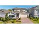 Charming two-story home with well-manicured landscaping and a brick driveway at 14321 Wabasso Loop, Winter Garden, FL 34787