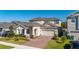 Charming two-story home with well-manicured landscaping and a brick driveway at 14321 Wabasso Loop, Winter Garden, FL 34787