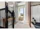 Welcoming foyer with staircase and view of front porch through the open door at 14321 Wabasso Loop, Winter Garden, FL 34787