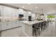 Modern kitchen with white cabinets, stainless steel appliances, and an island with seating at 14321 Wabasso Loop, Winter Garden, FL 34787