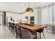 Modern kitchen and dining area with large wooden table and island with seating at 14321 Wabasso Loop, Winter Garden, FL 34787