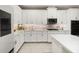 Bright kitchen featuring white cabinets, stainless steel appliances, and modern backsplash at 14321 Wabasso Loop, Winter Garden, FL 34787