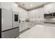 Bright kitchen features white cabinets, stainless steel appliances, and a modern design at 14321 Wabasso Loop, Winter Garden, FL 34787