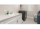 Well-equipped laundry room with white cabinetry, sink, and modern washer and dryer at 14321 Wabasso Loop, Winter Garden, FL 34787