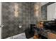 Chic powder room with dark designer wallpaper, a vessel sink, and stylish gold fixtures at 14321 Wabasso Loop, Winter Garden, FL 34787