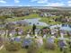 An aerial view of a lakefront community surrounded by golf course and trees at 1718 Golfview Dr, Kissimmee, FL 34746