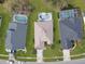 Aerial view of three homes each with their own screened in pool at 1718 Golfview Dr, Kissimmee, FL 34746