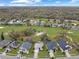 An aerial view of a golf course community with lakes and many trees at 1718 Golfview Dr, Kissimmee, FL 34746