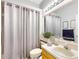 This bathroom features tile flooring, a white vanity, and a shower with a curtain at 1718 Golfview Dr, Kissimmee, FL 34746