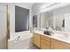 Bright bathroom featuring dual sinks, a soaking tub, and a large window at 1718 Golfview Dr, Kissimmee, FL 34746