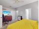 This bedroom features a ceiling fan, closet, a yellow comforter, and natural light at 1718 Golfview Dr, Kissimmee, FL 34746