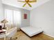 This bedroom features a ceiling fan and a bed with lots of natural light at 1718 Golfview Dr, Kissimmee, FL 34746