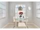 Bright dining area with glass table, white chairs, natural light, and modern pendant light at 1718 Golfview Dr, Kissimmee, FL 34746