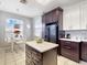 Modern kitchen with an island, stainless steel appliances, and an adjacent dining area at 1718 Golfview Dr, Kissimmee, FL 34746