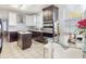 This kitchen features stainless steel appliances, tile floors, an island, and a modern design at 1718 Golfview Dr, Kissimmee, FL 34746