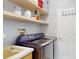 Laundry room showcasing a front load washer and dryer, sink and shelving at 1718 Golfview Dr, Kissimmee, FL 34746