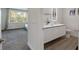 Bright bathroom featuring a modern vanity with double sinks and a sleek, illuminated mirror at 17238 Blessing Dr, Clermont, FL 34714