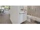 An airy bathroom featuring modern fixtures, walk-in shower, and luxury finishes at 17238 Blessing Dr, Clermont, FL 34714