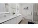 Sleek bathroom features double sinks with illuminated mirrors, white cabinets, and modern fixtures at 17238 Blessing Dr, Clermont, FL 34714