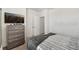 Bright bedroom featuring soft carpeting, comfortable bed, and a modern dresser with a flat screen tv at 17238 Blessing Dr, Clermont, FL 34714