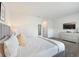 Bright, spacious bedroom with plush carpeting, a comfortable bed, and a large television at 17238 Blessing Dr, Clermont, FL 34714
