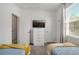 Bright bedroom with two beds, stylish decor, and ample natural light at 17238 Blessing Dr, Clermont, FL 34714