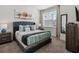 Stylish bedroom features a comfortable bed, soft carpeting, and a picturesque window with natural light at 17238 Blessing Dr, Clermont, FL 34714