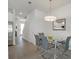 Contemporary dining room with a glass table, modern chairs, and stylish light fixture at 17238 Blessing Dr, Clermont, FL 34714