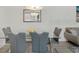 Close up of the dining area showcasing modern chairs, a glass table, and a contemporary aesthetic at 17238 Blessing Dr, Clermont, FL 34714