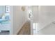 Bright hallway with carpeted floors leading to a bedroom with a twin bed, enhancing the home's appeal at 17238 Blessing Dr, Clermont, FL 34714