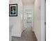 Upstairs hallway with picture frame and view of bedroom at 17238 Blessing Dr, Clermont, FL 34714