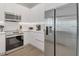 Contemporary kitchen with stainless steel appliances and white cabinetry for a clean, modern look at 17238 Blessing Dr, Clermont, FL 34714
