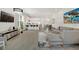Spacious living room featuring modern decor, open to the kitchen and dining area, perfect for entertaining at 17238 Blessing Dr, Clermont, FL 34714
