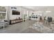Bright, open-concept living room with modern furnishings and a view of the kitchen and dining area at 17238 Blessing Dr, Clermont, FL 34714