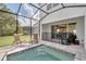 Enclosed pool area with lounge chairs and a jacuzzi at 17238 Blessing Dr, Clermont, FL 34714
