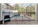 Screened in backyard pool with lounge seating at 17238 Blessing Dr, Clermont, FL 34714