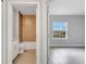 Bathroom with granite counters, white cabinets, tile flooring, and tiled shower at 1783 Coriander Dr, Kissimmee, FL 34759