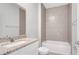 Bathroom featuring granite countertops, white cabinets, and a tiled shower at 1783 Coriander Dr, Kissimmee, FL 34759