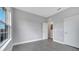 Neutral gray bedroom with tiled floor and white doors at 1783 Coriander Dr, Kissimmee, FL 34759