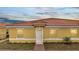 Exterior elevation of a home with a red-tile roof and manicured front yard at 1783 Coriander Dr, Kissimmee, FL 34759