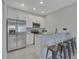 Well-equipped kitchen with stainless steel appliances, granite countertops, and a convenient breakfast bar at 1783 Coriander Dr, Kissimmee, FL 34759