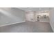 Open living space with gray tile floors and an airy layout leading to the kitchen at 1783 Coriander Dr, Kissimmee, FL 34759