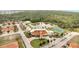 Stunning aerial view of community clubhouse, pool, pond, and tennis courts surrounded by lush greenery at 1785 Coriander Dr, Kissimmee, FL 34759