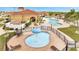 Aerial view of the lagoon style pool with lounge chairs, pool with fountain, and clubhouse at 1785 Coriander Dr, Kissimmee, FL 34759